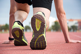 Starting Stories: 5 Great Beginning Strategies Photo of a runner crouching at the starting line of a track